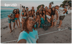 TrovaTrip group of travelers taking a selfie on the beach with ocean in background