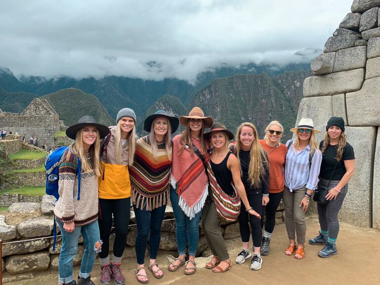 TrovaTrip travelers smiling in front of mountains in Peru