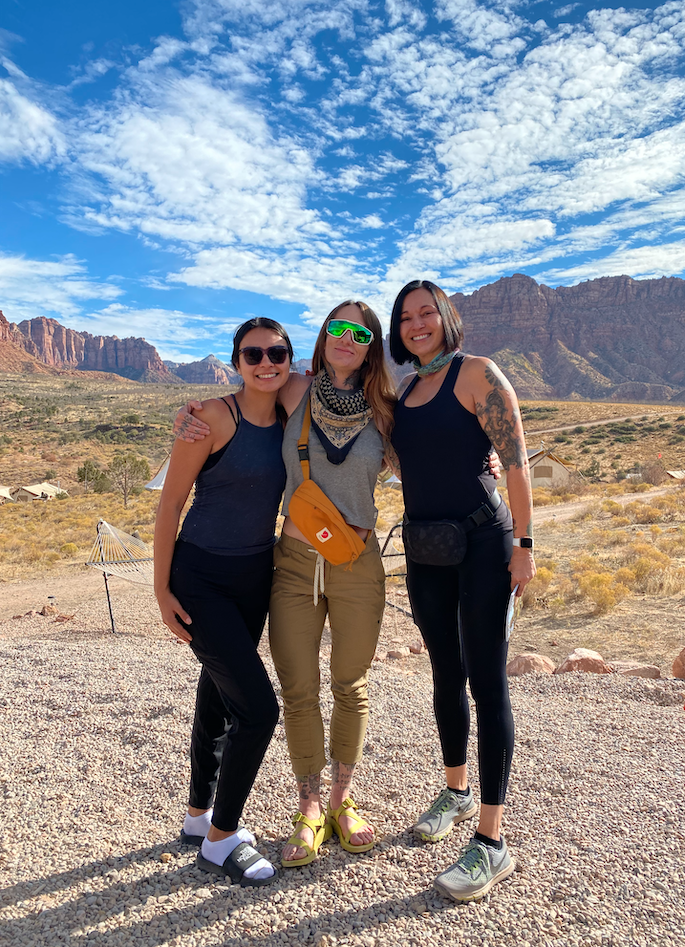 TrovaTrip three people smiling with mountains in background