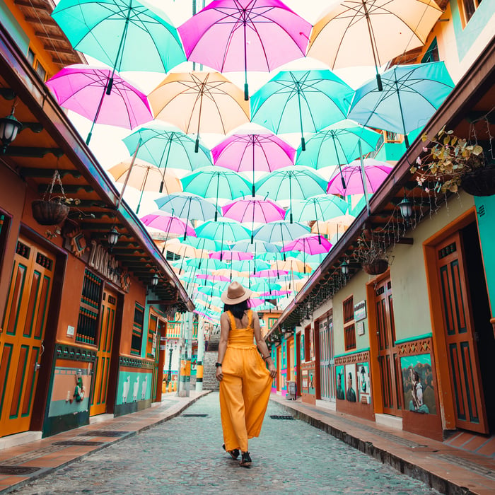 Photo of woman looking at umbrellas in Colombia.