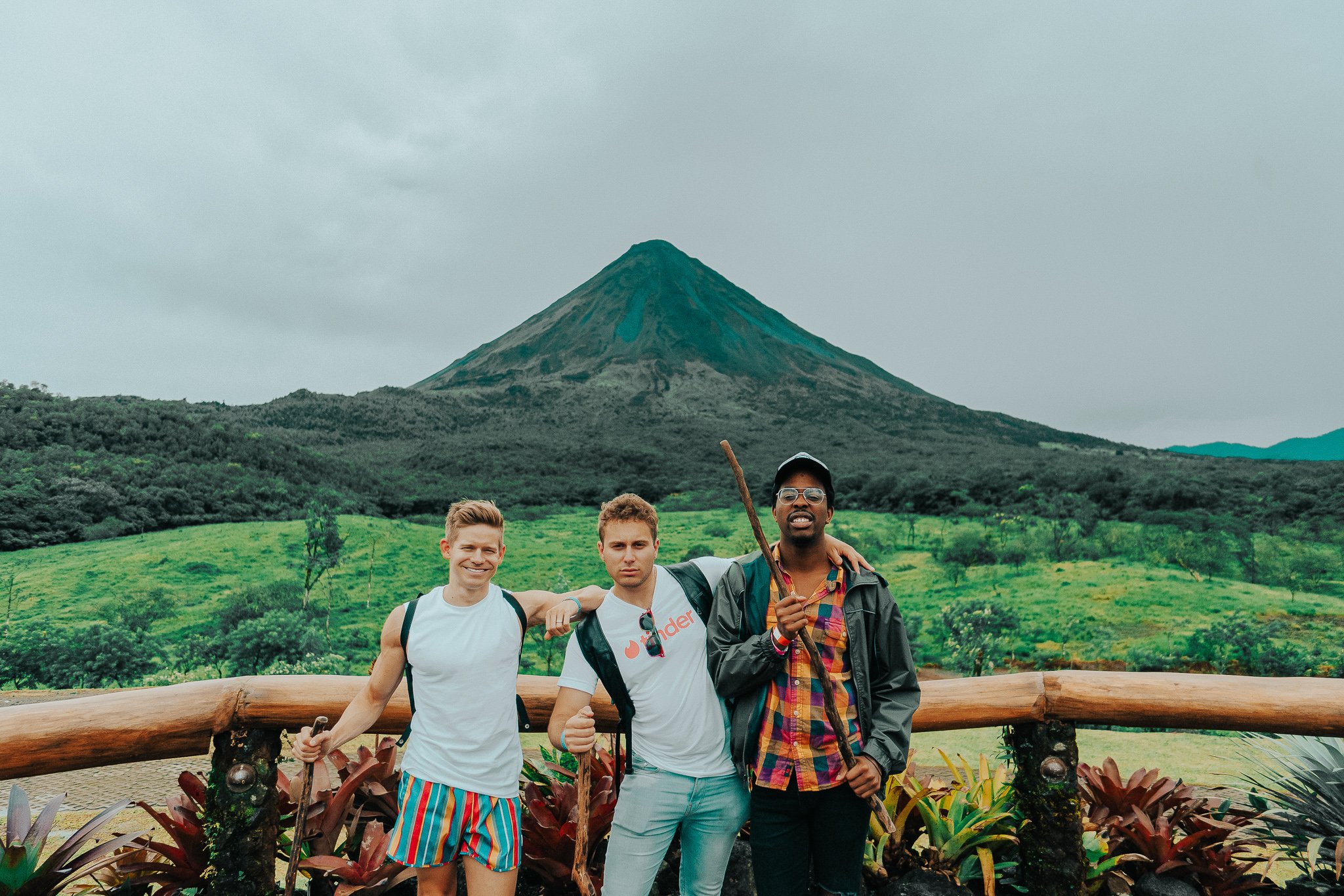 TrovaTrip three men posing in front of a volcano in lush Costa Rica jungle