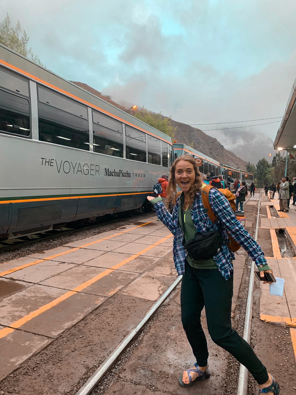 TrovaTrip woman pointing at the voyager Machu Picchu train in Peru