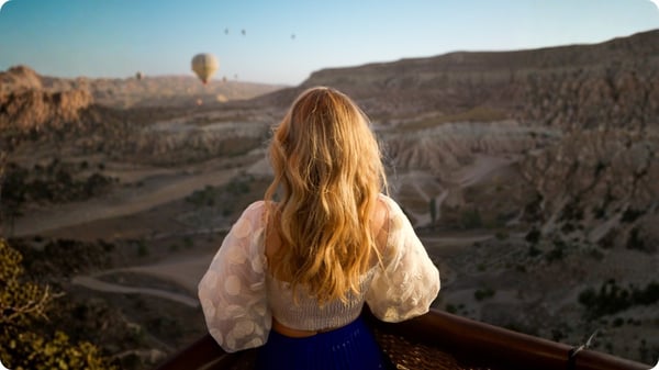 A woman on one of TrovaTrip's travel groups exploring Cappadocia's hot air balloons in Turkey.