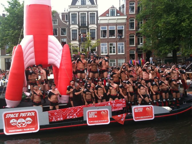 TrovaTrip group of shirtless men celebrating on a space patrol float in the Netherlands