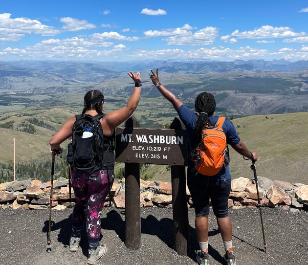 Two women on a TrovaTrip summiting Mt. Washburn in Yellowstone National Park.