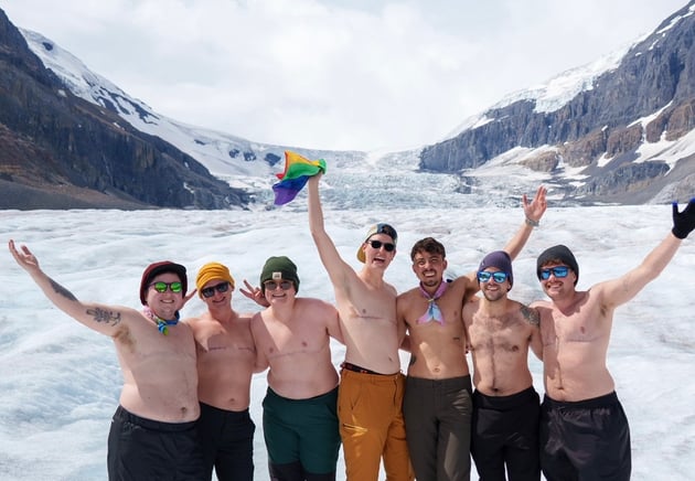 Transgender host leading a queer-friendly group trip, promoting safe and inclusive travel experiences