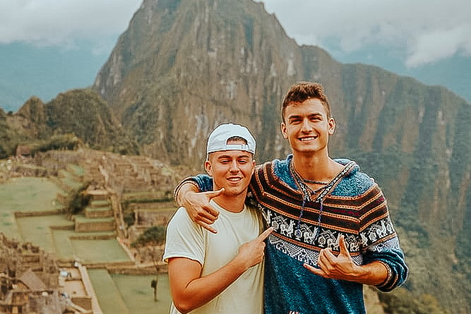 TrovaTrip Peru two men smiling in front of mountain