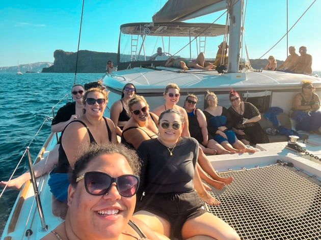 Group of women on a boat tour in Greece, one of the best places to travel to in the spring.