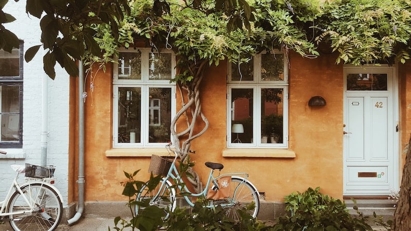 A bicycle leaning up against a building in Denmark.