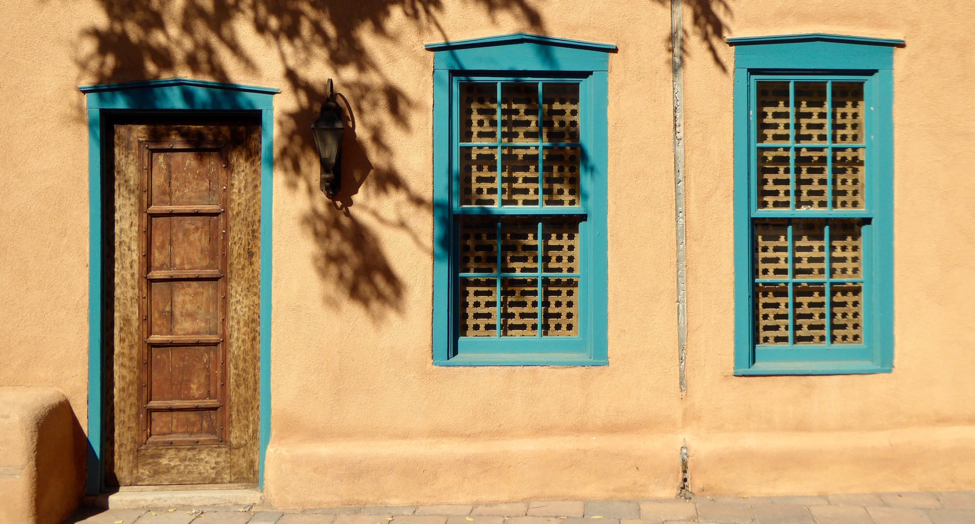 Building with blue trimmed door and windows in Santa Fe, New Mexico.