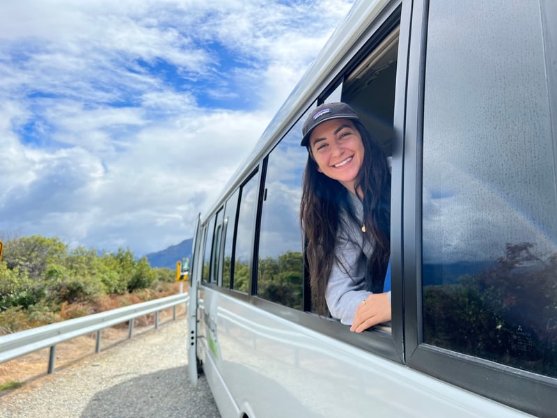 TrovaTrip Host @angelaliggs on a bus in New Zealand during a group trip.