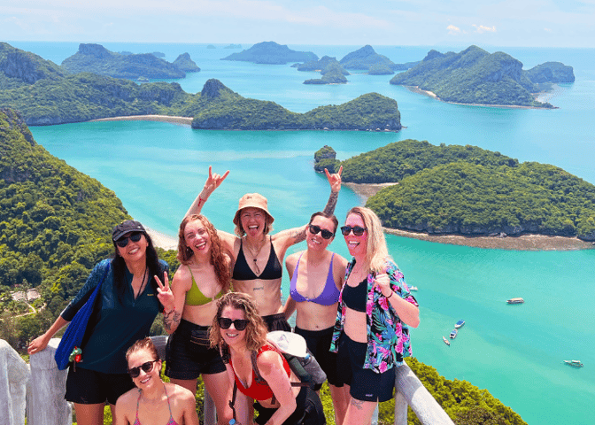 TrovaTrip group smiling overlooking islands.