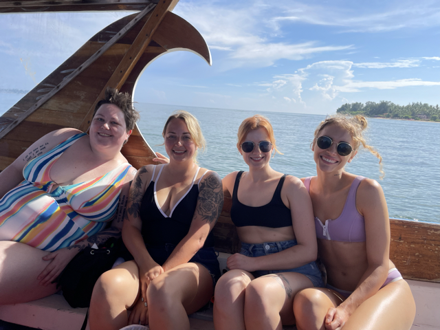 Host Ash Morgan and group travelers on a boat in Bali.