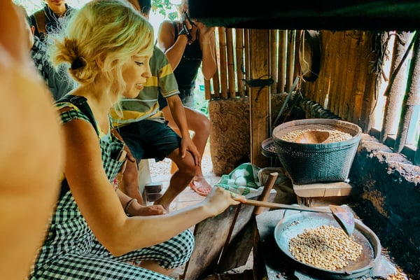 TrovaTrip Bali woman shuffling coffee beans during cooking class