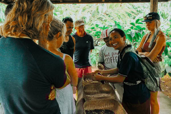 TrovaTrip Bali group of travelers surrounding coffee beans