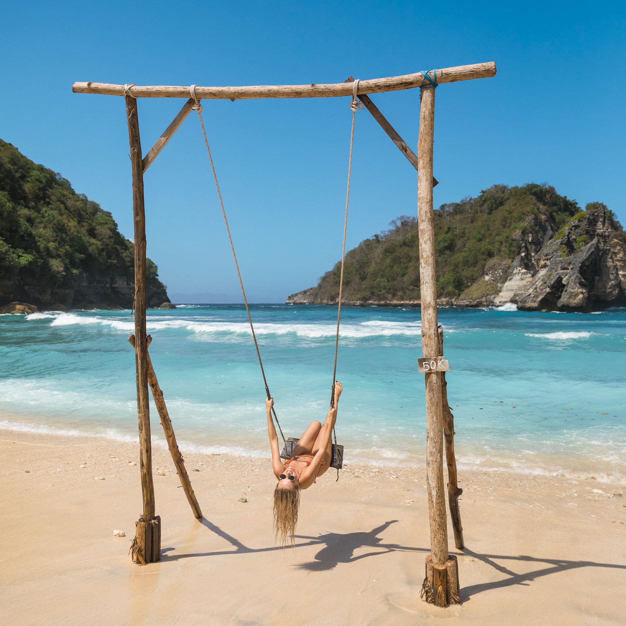 TrovaTrip Traveler on a swing in Bali.