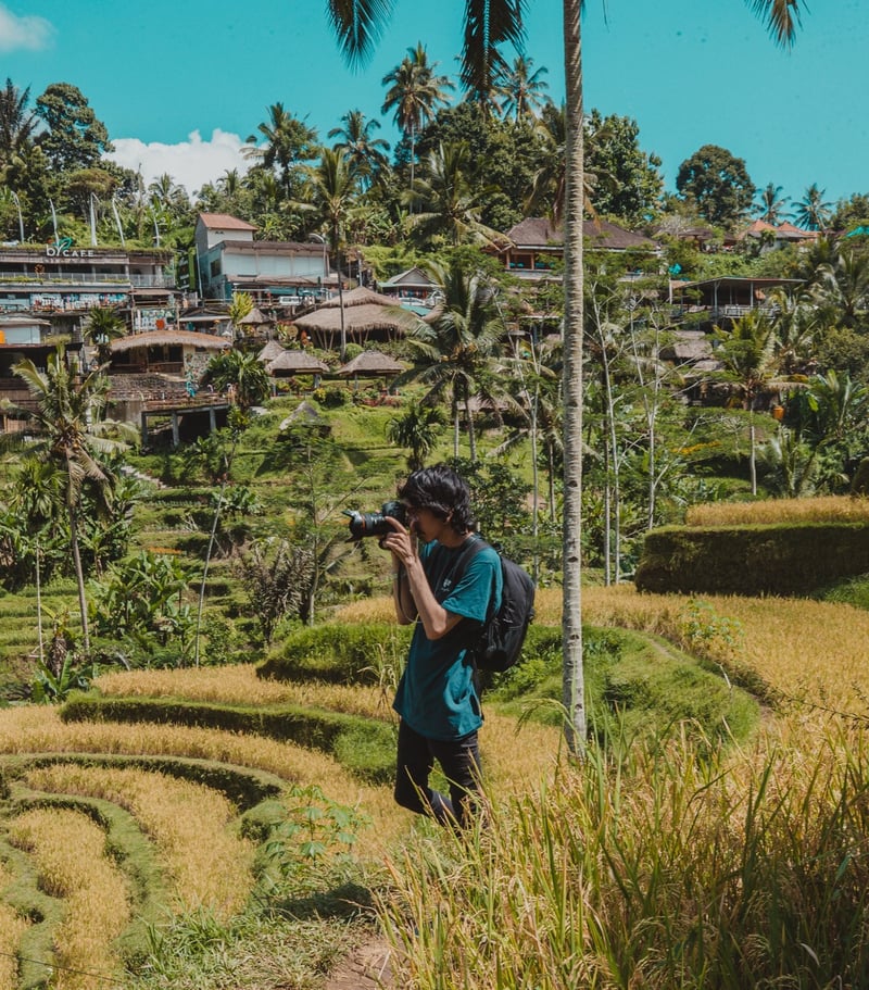 TrovaTrip Traveler taking photos in rice fields in Bali.