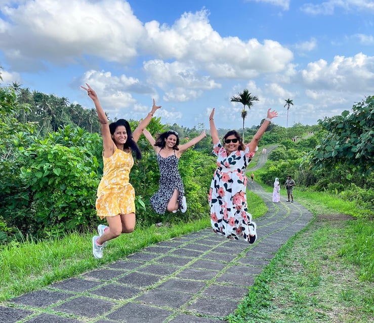 Three TrovaTrip Travelers jumping for joy in Bali.