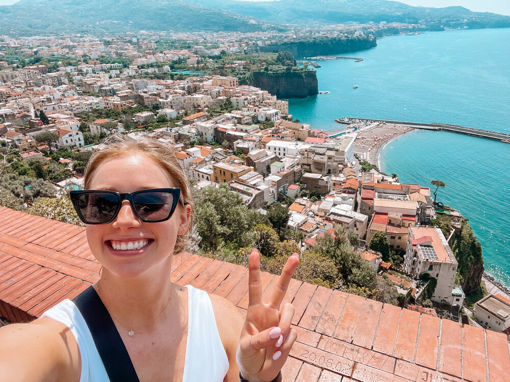 Traveler holding up peace sign in Italy, great place to visit in September.