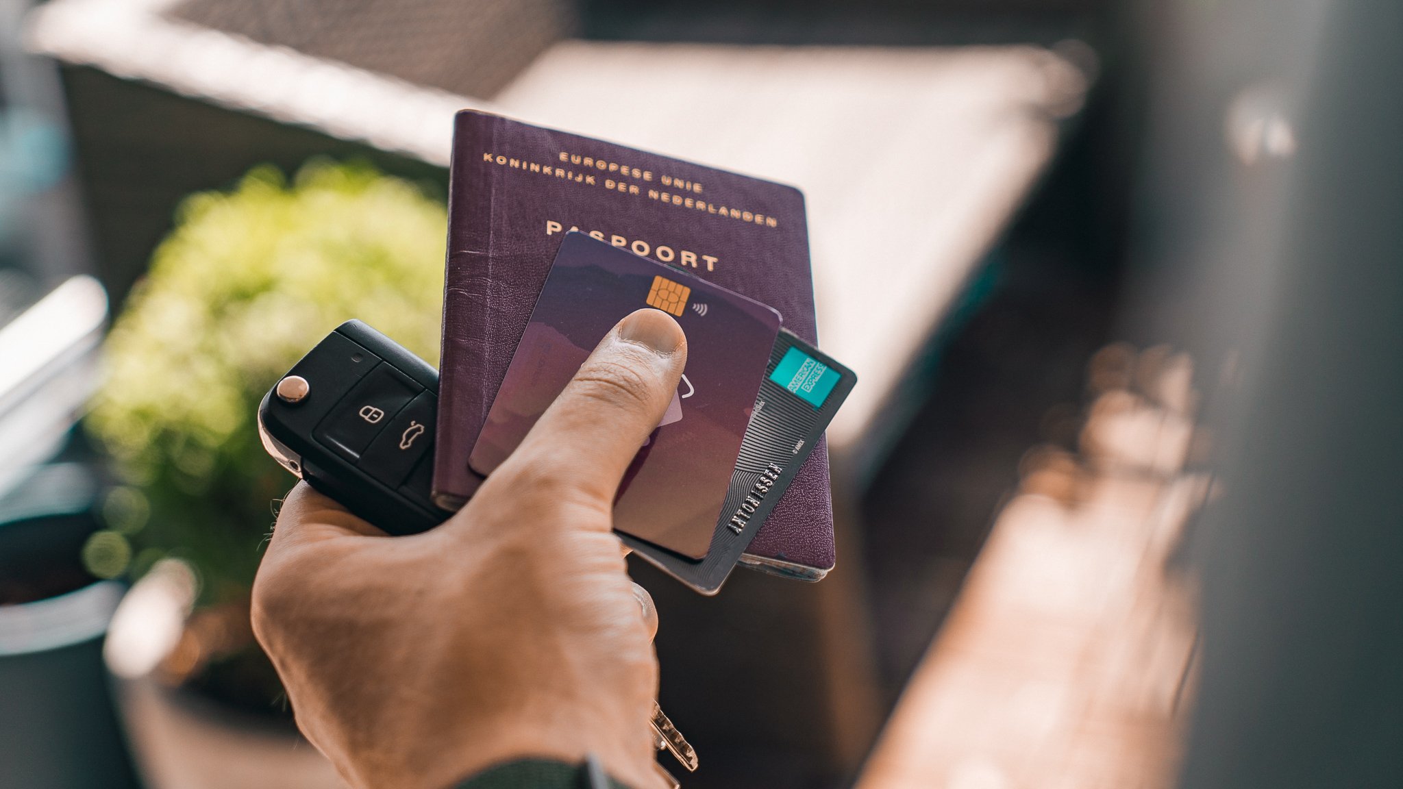 TrovaTrip hand holding a credit card passport and keys