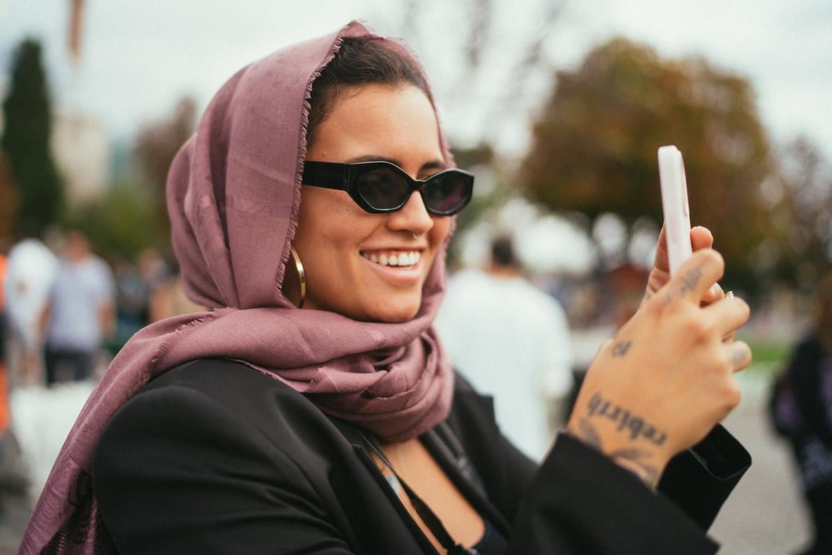 Person looking on their phone at travel insurance plans for their Trova Trip.