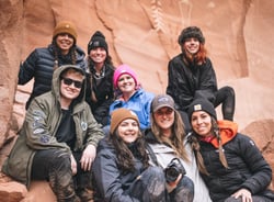 TrovaTrip Coyote Gulch group of travelers in canyon smiling at camera
