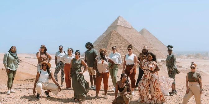 TrovaTrip group with fawziah in Egypt near pyramids.