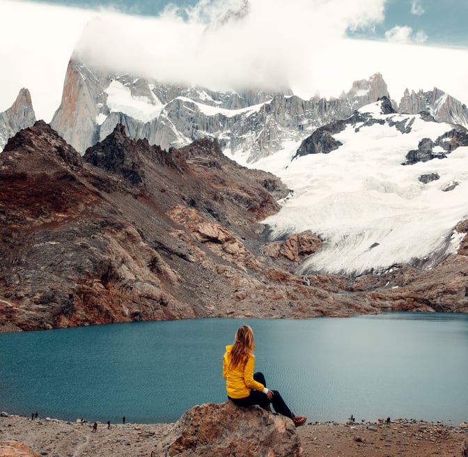 TrovaTrip Host Chelsea Williams sitting near Fitz Roy, Patagonia.
