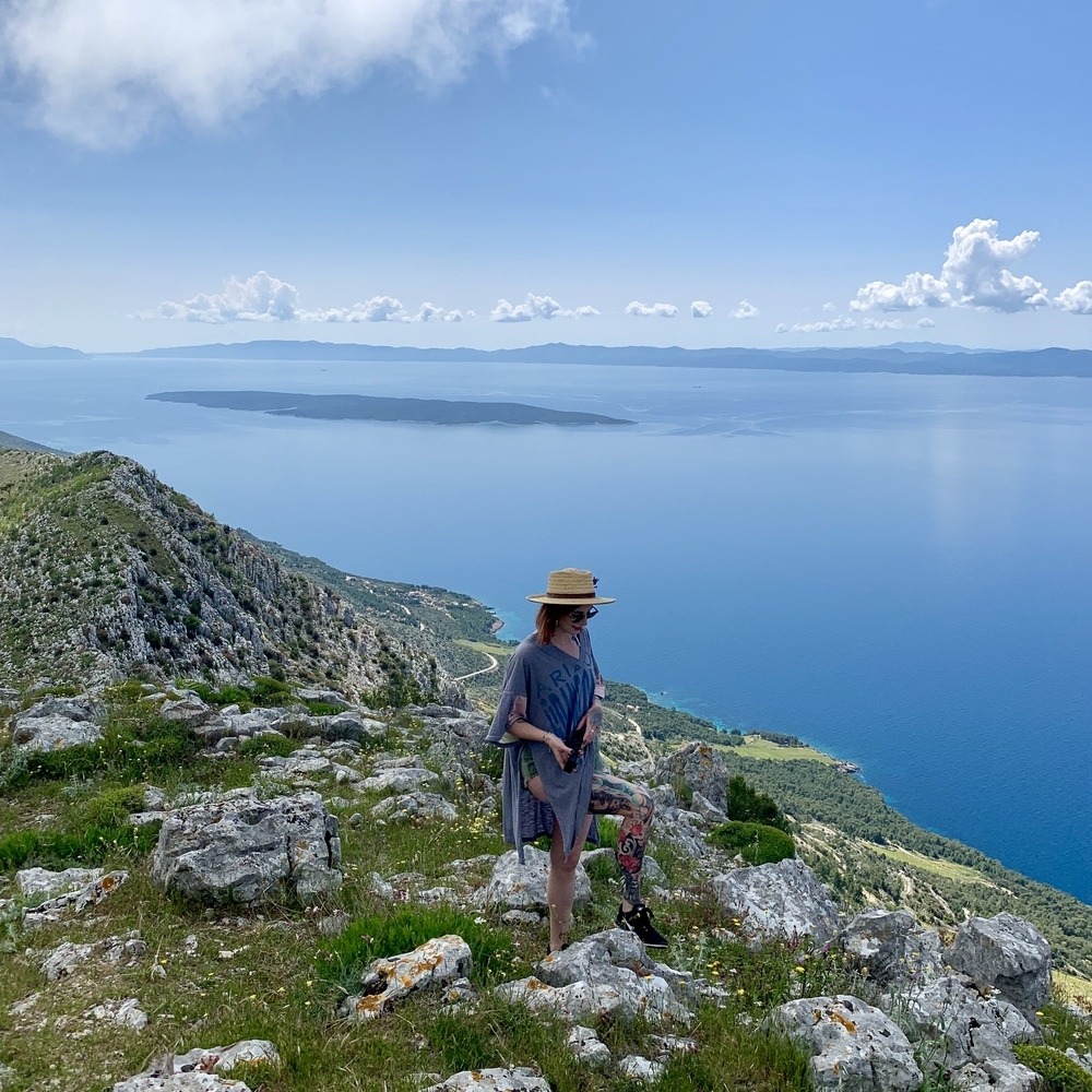 Person along the coastline in Croatia, one of the best places for travel in September.