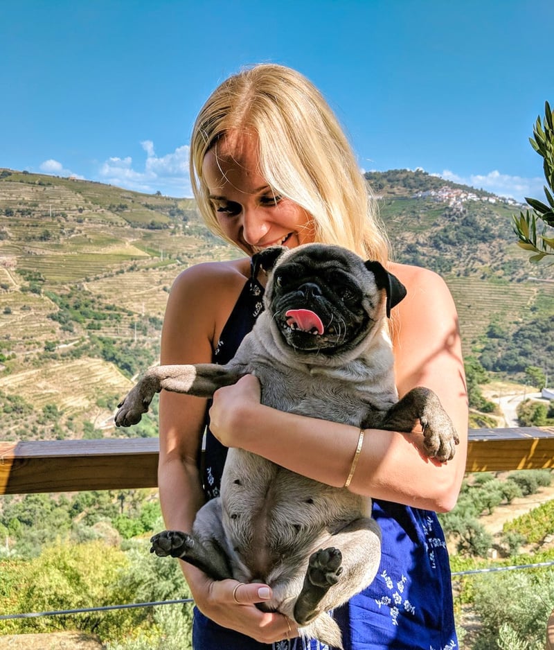 TrovaTrip Traveler in Portugal on a group trip with Travel Blogger Helene Sula, holding a pug.