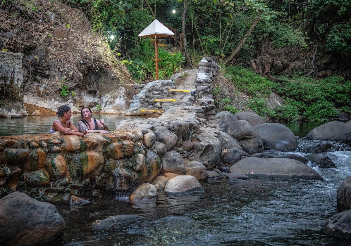 Two travelers relaxing in a hot spring in Costa Rica.