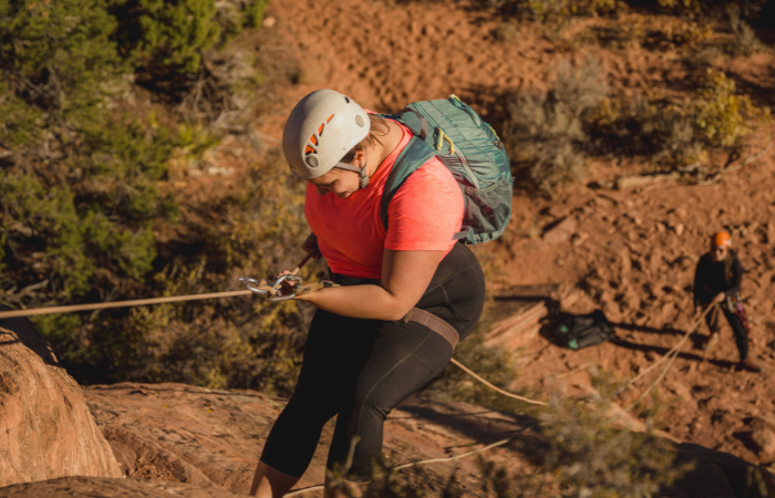 TrovaTrip Traveler rock climbing in Zion, Utah.