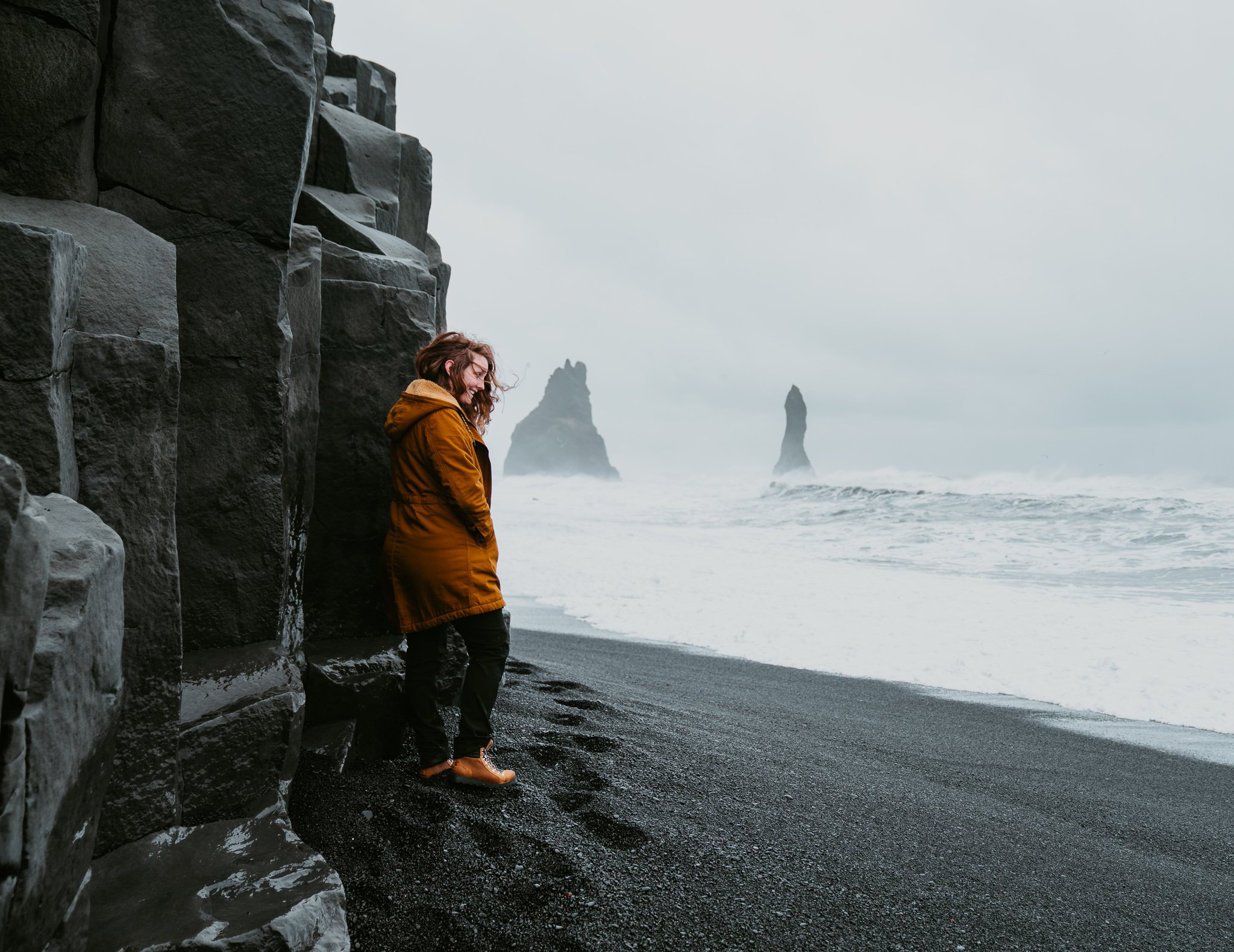 TrovaTrip person on black sand beach Iceland