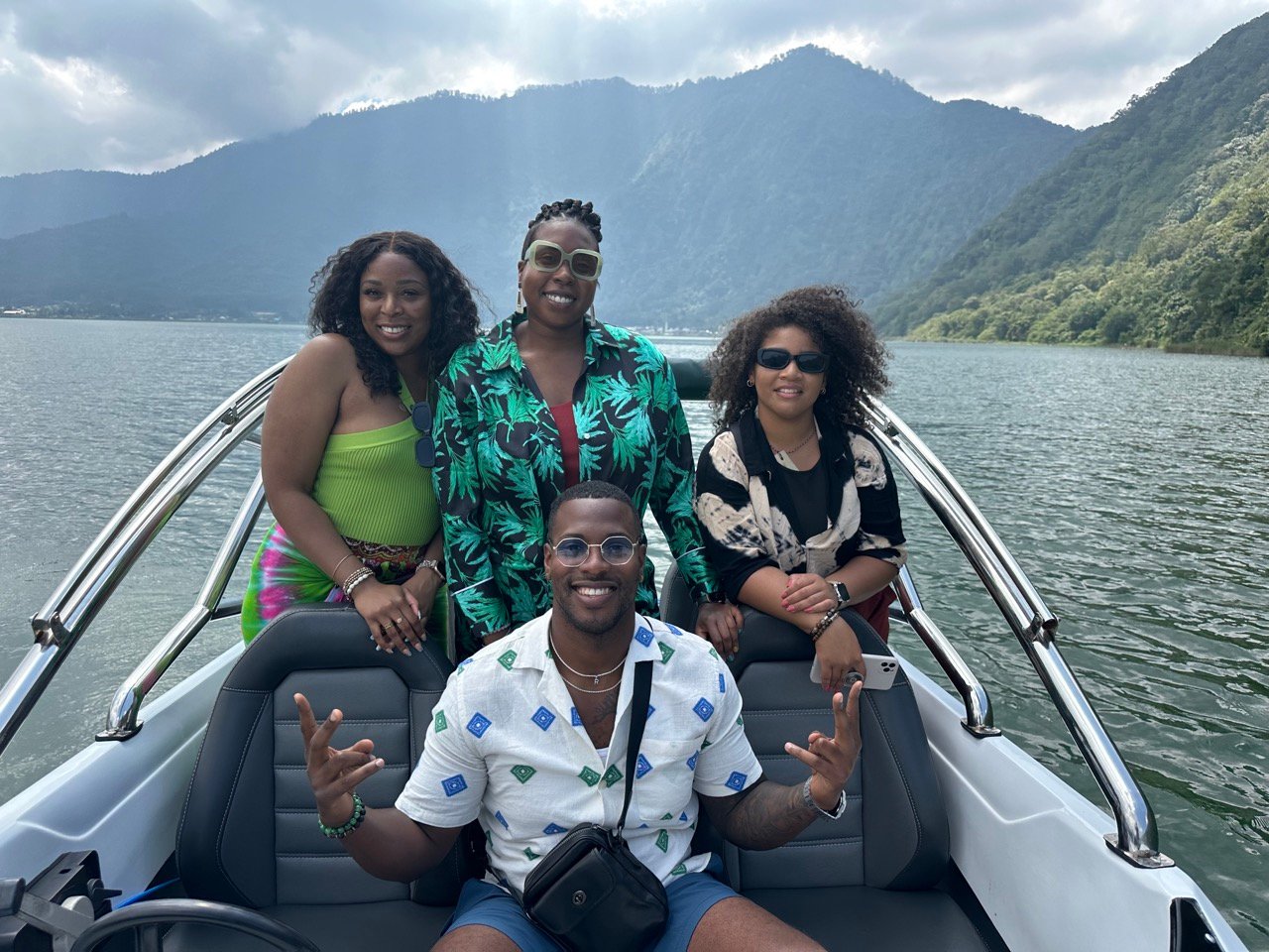 A TrovaTrip Host leading travel groups on a boat tour in Bali.