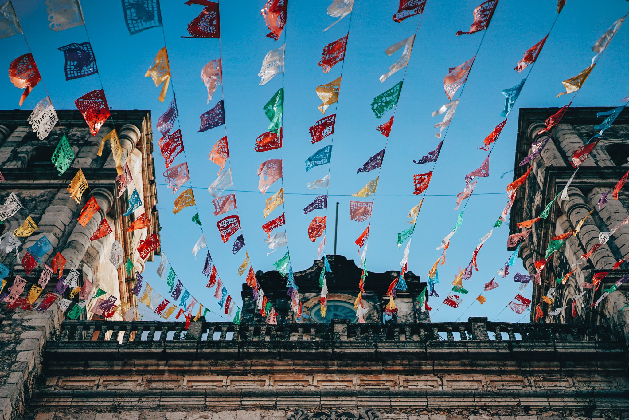 Banners in the sky above a building in Mexico.