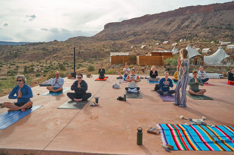 TrovaTrip Host miamiyogagirl leading meditation for her group in a Zion National Park yoga retreat.