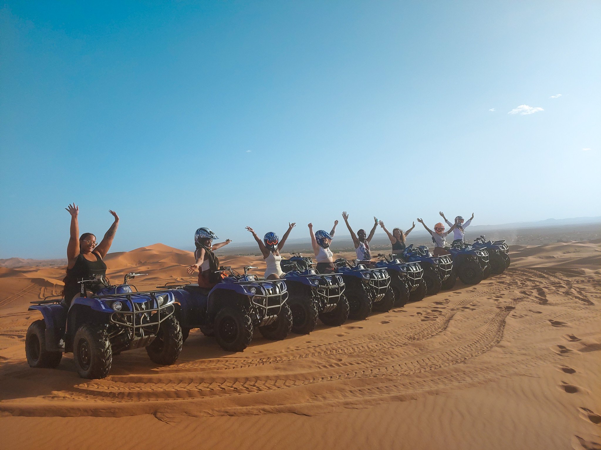 TrovaTrip Host and Travelers riding ATVs in Morocco.
