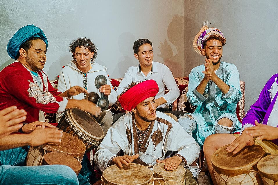 TrovaTrip locals wearing traditional clothes and playing music in Morocco
