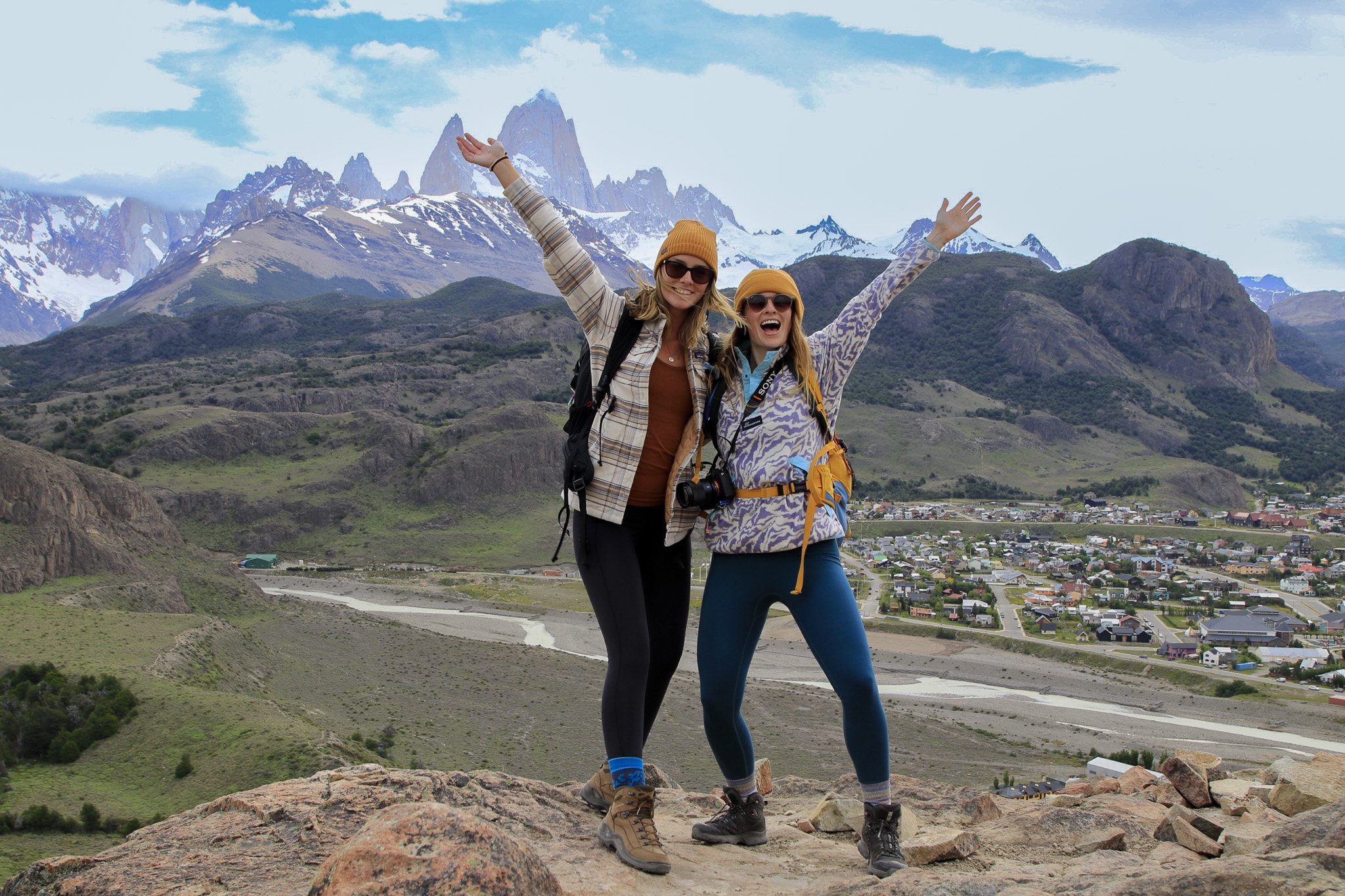 Two TrovaTrip Travelers posing in front of a mountain in Patagonia.
