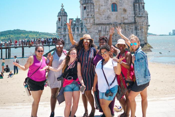 TrovaTrip Portugal Group smiling with hands in the air.