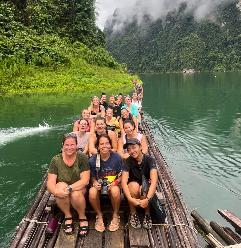 Content Creator and TrovaTrip Host Ally Coucke @acoucke and Travelers on a boat during group trip in Thailand.