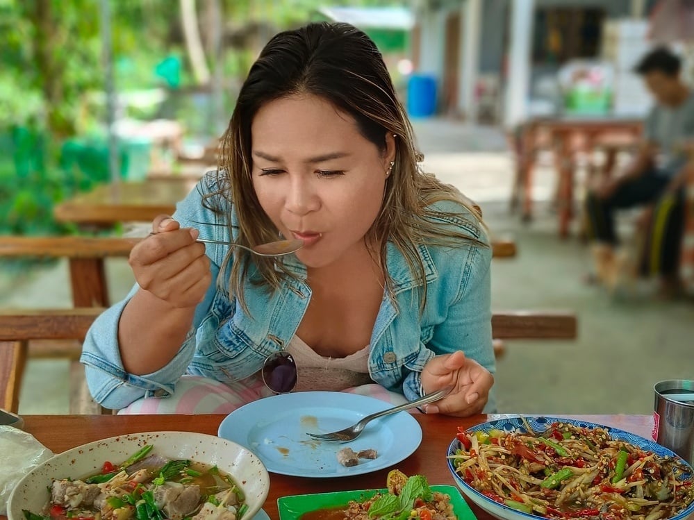 Person dining in Thailand, one of the best places to travel in 2026 for cuisine.