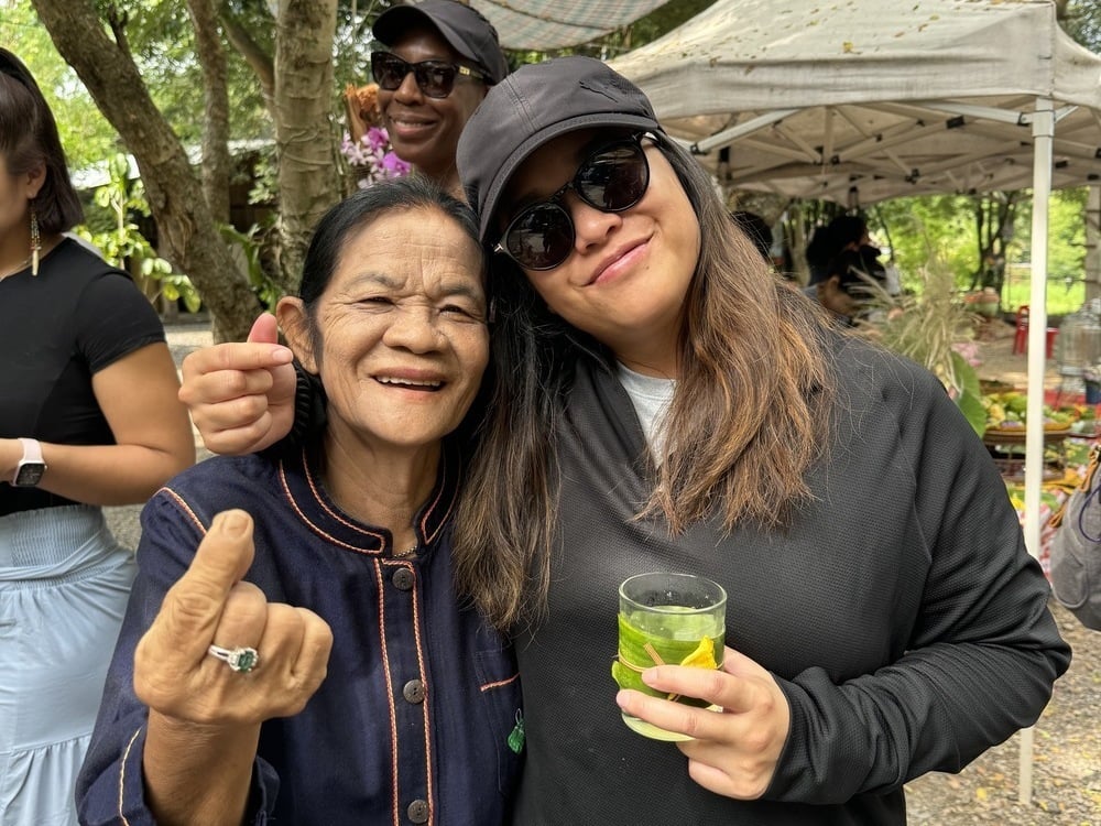 Traveler and local smiling in Thailand, one of the best places to travel in January.