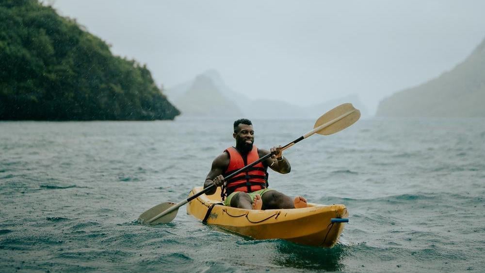 Person kayaking in Thailand, a great place to visit in January.