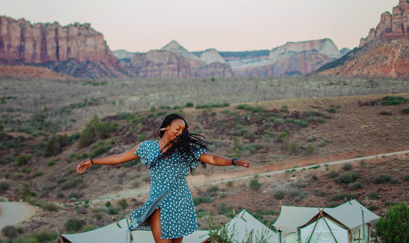 Woman dancing on a TrovaTrip in Zion.