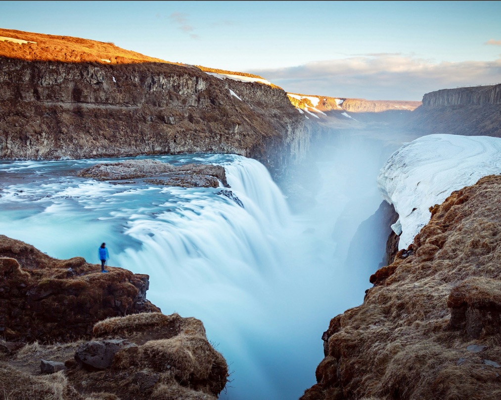 Travelers can take a group trip to Iceland to view waterfalls with TrovaTrip.