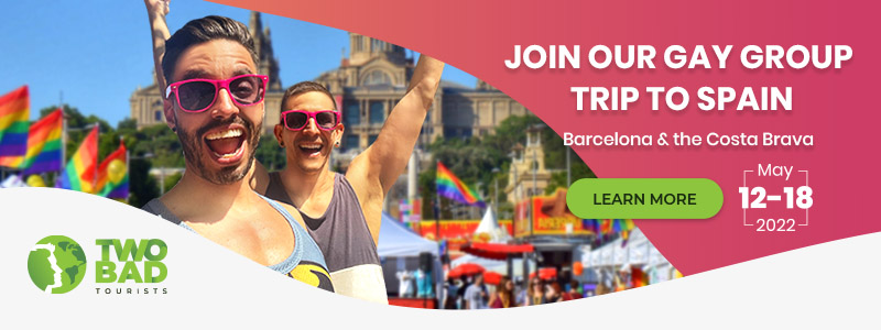 TrovaTrip flyer promoting Two Bad tourist with two men wearing sunglasses in front of a festival displaying pride flags text says: Join our Gay Group Trip to Spain