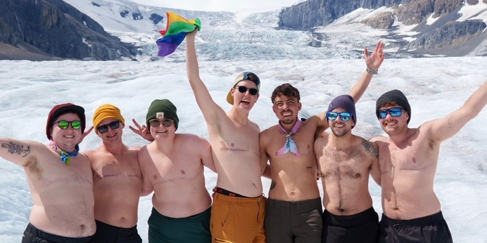 Transgender travel hosts sharing stories for Transgender Day of Visibility, highlighting inclusive group travel and community.