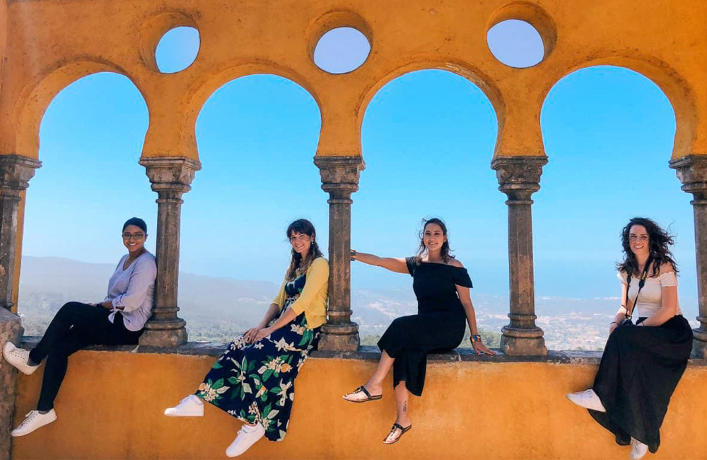 Group of Travelers sitting at historical landmark on Helene Sula's TrovaTrip in Portugal.